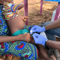 Person receiving a vaccine injection in a rural setting