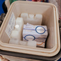 Medication boxes in a cooler with visible branding
