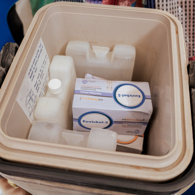 Medication boxes in a cooler with visible branding